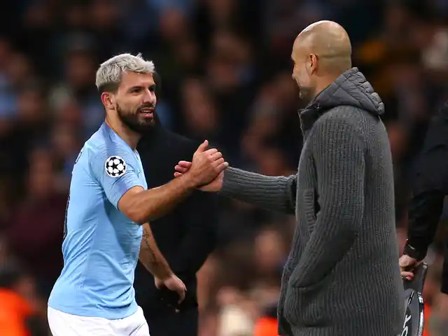 Manchester City coach Pep Guardiola, right, shakes hands with Manchester City’s Sergio Aguero during the Champions League round of 16 second leg, soccer match between Manchester City and Schalke 04 at Etihad stadium in Manchester, England, Tuesday, March 12, 2019.