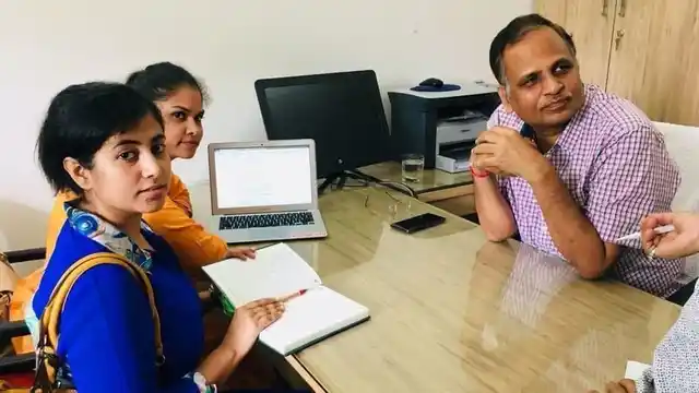 Petitioner Bhavya Singh with Delhi PWD Minister Satyendra Jain.