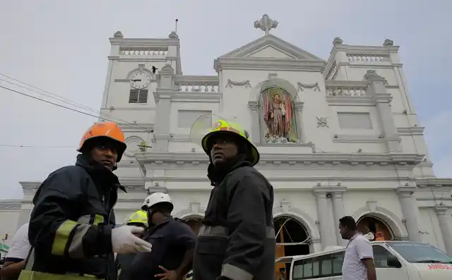 Sri Lankan firefighters stand in the area around St Anthony’s Shrine after a blast in Colombo.