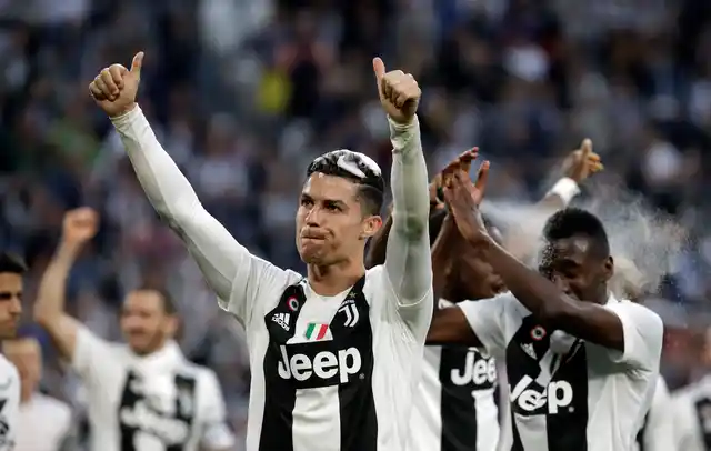 Juventus’ Cristiano Ronaldo celebrates with his teammates at the end of a Serie A soccer match between Juventus and AC Fiorentina, at the Allianz stadium in Turin, Italy, Saturday, April 20, 2019.