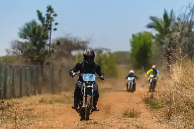 Riding the modified-for-the-dirt Apache RTR 200.