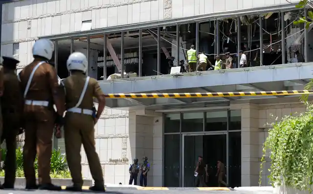 Police and forensic officials inspect a blast spot at the Shangri-la hotel in Colombo.