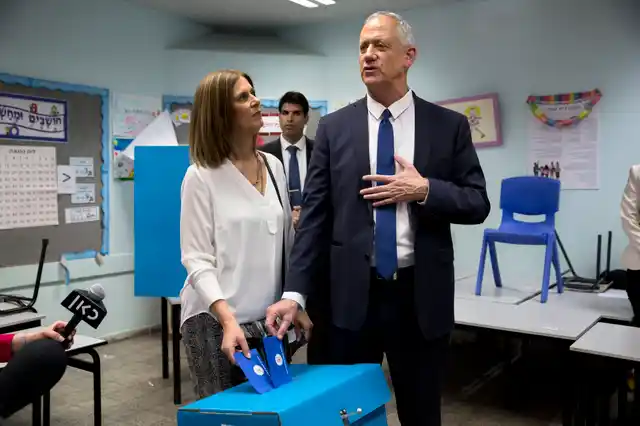 Netanyahu’s main challenger Benny Gantz casts his vote along with wife Revital Gantz