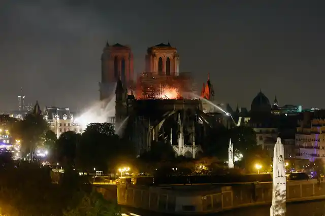 Firefighters tackle the blaze as flames and smoke rise from Notre Dame cathedral as it burns in Paris, Monday, 15 April, 2019.