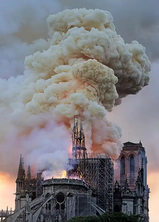 Flames and smoke rise as the spire on Notre Dame cathedral collapses in Paris.