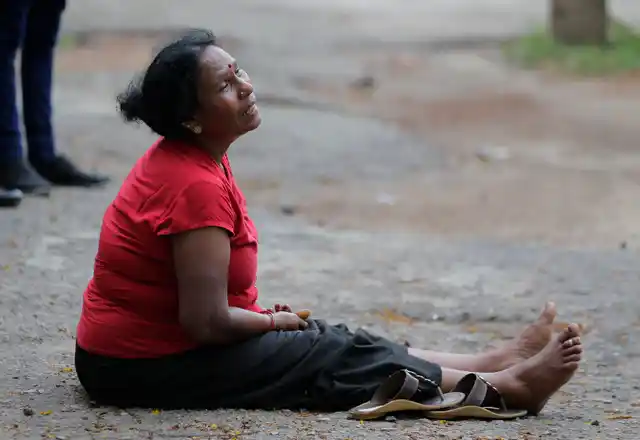 A relative of a blast victim grieves outside a morgue in Colombo