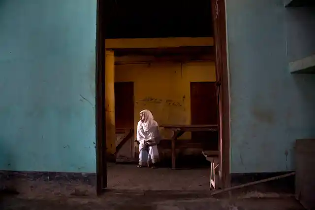 An elderly woman waits to cast her vote during the third phase of general election in Guwahati.