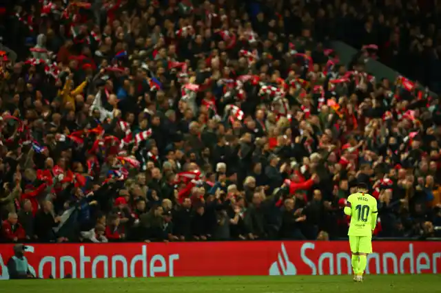 Barcelona’s Lionel Messi walks as Liverpool’s Divock Origi celebrates scoring his side’s 4th goal during the Champions League semifinal, second leg, soccer match between Liverpool and FC Barcelona.