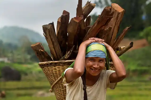 Khasi tribal woman Lona Syngkli carries firewood in a basket swung around her head in Nongpoh, Meghalaya. 