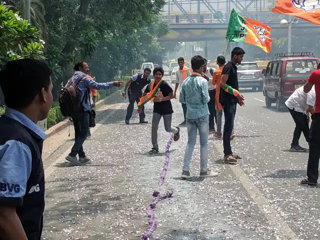 Supporters took to the road outside the BJP HQ to celebrate