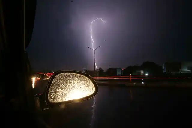 A bolt of lighting illuminates the night sky as it rains in Jammu.
