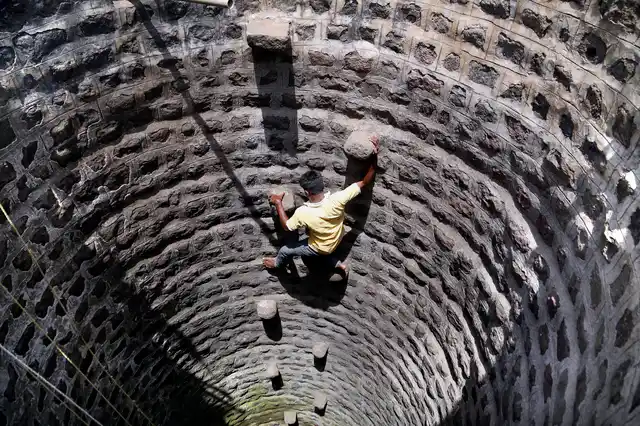 A villager climbs down a well to fetch water, in a wada of Dhasai village in Murbad taluk of Thane district. Dhasai. Some reports suggest that authorities are not supplying water to the village regularly, making the excuse of model code of conduct due to ongoing Lok Sabha elections.