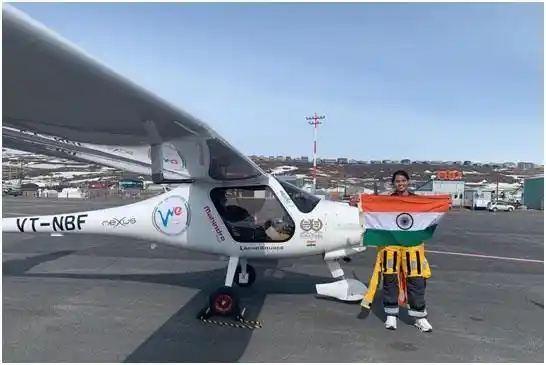 Captain Aarohi Pandit poses with the Indian flag after landing in Canada on May 14, 2019.