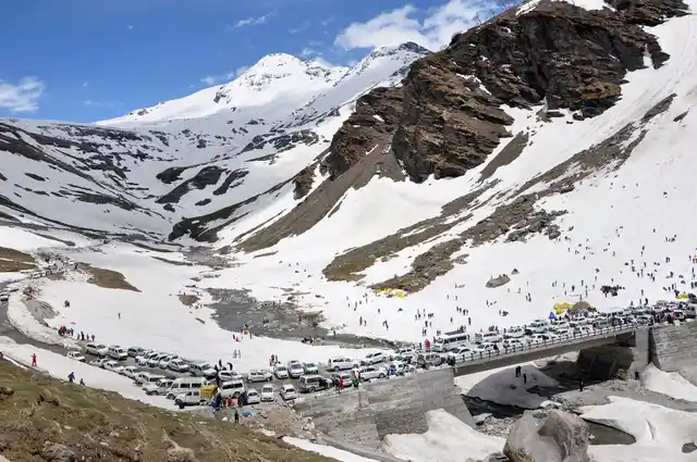 Tourists flock the Rohtang pass, a popular destination for North Indians looking to escape the summer heat, after it opened for public on Sunday, 5 May.