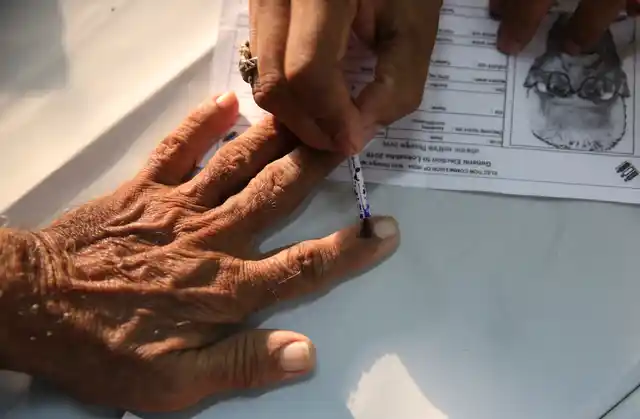 An elderly citizen gets ink mark on his finger prior to voting at a polling center during the fourth phase of general elections in Mumbai, on Monday, 29 April 2019. The voting over seven phases ends on 19 May, with counting scheduled for 23 May.
