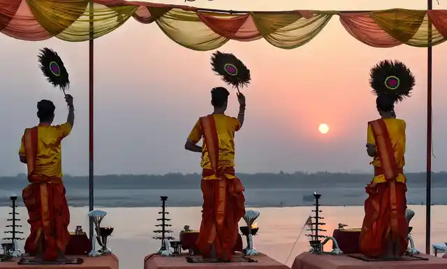 Temple priests perform ‘Ganga Aarti’ during dawn at Assi ghat, in Varanasi, 