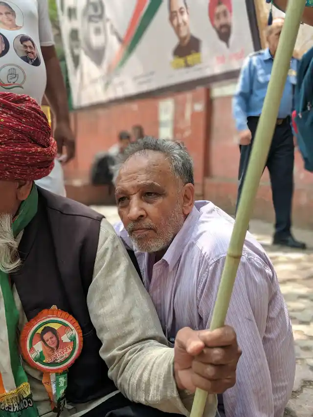 A congress supporter sits outside the headquarters