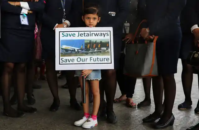 Daughter of a Jet Airways employee holds a placard at a silent protest organised by employees at the Chhatrapati Shivaji Maharaj International Airport Mumbai, India, Wednesday, 1 May 2019. 