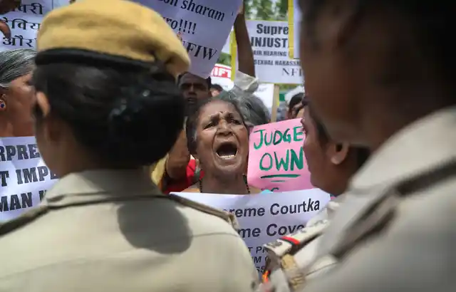 Indian women activists shout slogans during a protest against a court inquiry that cleared India’s Chief Justice of sexual harassment allegations made by a former employee at his official residence, in New Delhi.
