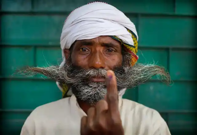 An Indian displays indelible ink mark on his index finger after casting his vote in the seventh and final phase of national elections, on the outskirts of Varanasi. 