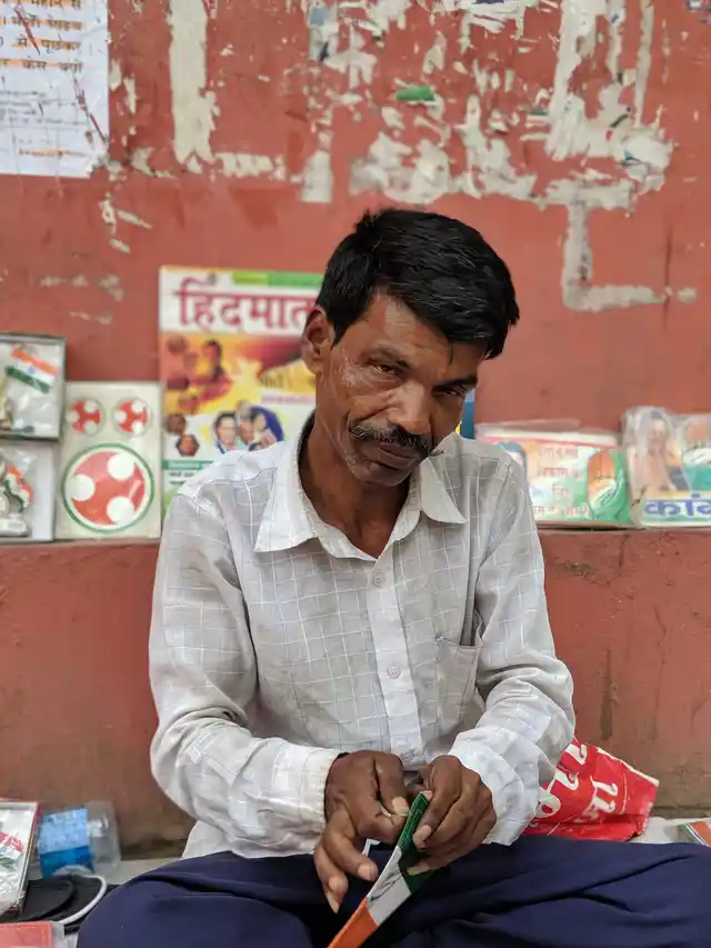 A shopkeeper packs up his stuff after the the area outside Congress HQ empties out by mid-day