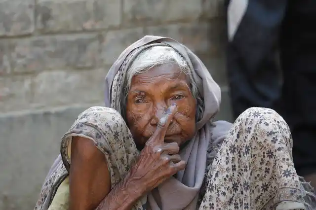 An elderly woman displays indelible ink mark on her finger after casting her vote during the seventh and final phase of national elections, on the outskirts of Varanasi. 