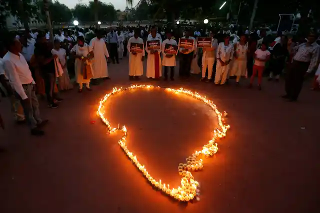 Indians make an outline of Sri Lankan map with lighted candles after a peace march to express solidarity with people of Sri Lankan, in Ahmadabad on Sunday, 28 April 2019. 