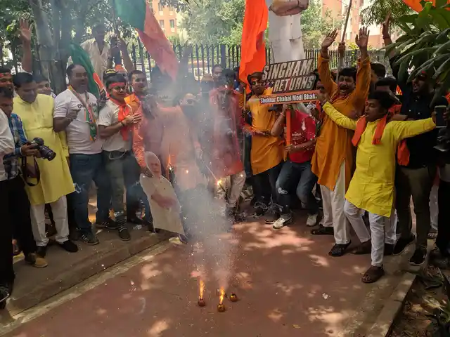 BJP supporters and workers light fireworks outside BJP HQ.