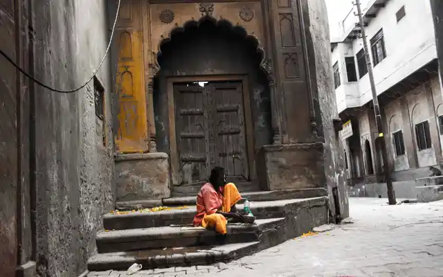 A blind saint outside the door of old Mira bai temple, where she stayed and worshiped Krishna in early 16th century. The doors of the temple remain shut permanently. The temple town draws a large number of visitors not just on account of religious importance but also on account of its historical eminence from the patronage it enjoys through medieval saints like Swami Haridas, Tansen, Kabir as well as Mira Bai.
