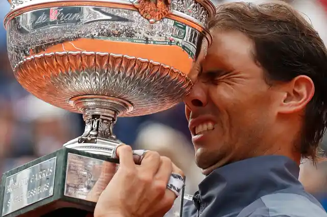 Spain’s Rafael Nadal holds the trophy as he celebrates his record 12th French Open tennis tournament title after winning his men’s final match against Austria’s Dominic Thiem in four sets, 6-3, 5-7, 6-1, 6-1, at the Roland Garros stadium in Paris, Sunday, June 9, 2019. 