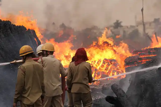 Firefighters douse flames at a timber godown, in Toph Sherkhanian area of Jammu on Tuesday, 11 June. 