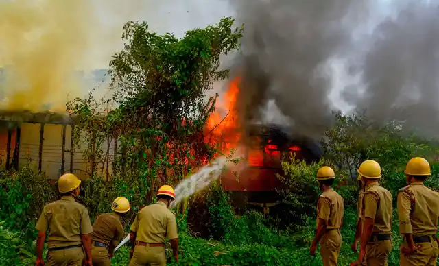 Firefighters try to douse a massive fire at abandoned railway coaches near Howrah station in Howrah, Monday, 17 June 2019. 