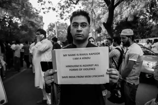 ‘Hinduism is against all forms of violence,’ reads a placard held up by a man at the Jantar Mantar protest on Wednesday. 
