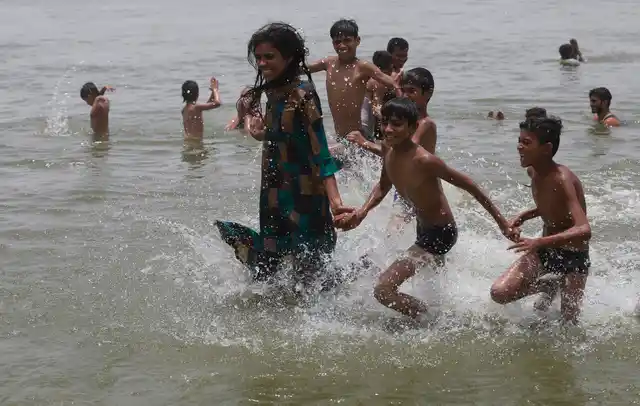 Children play in the River Ganges on a hot day in Prayagraj, India, Sunday, 16 June, 2019. Many parts of India are experiencing extreme heat conditions. 