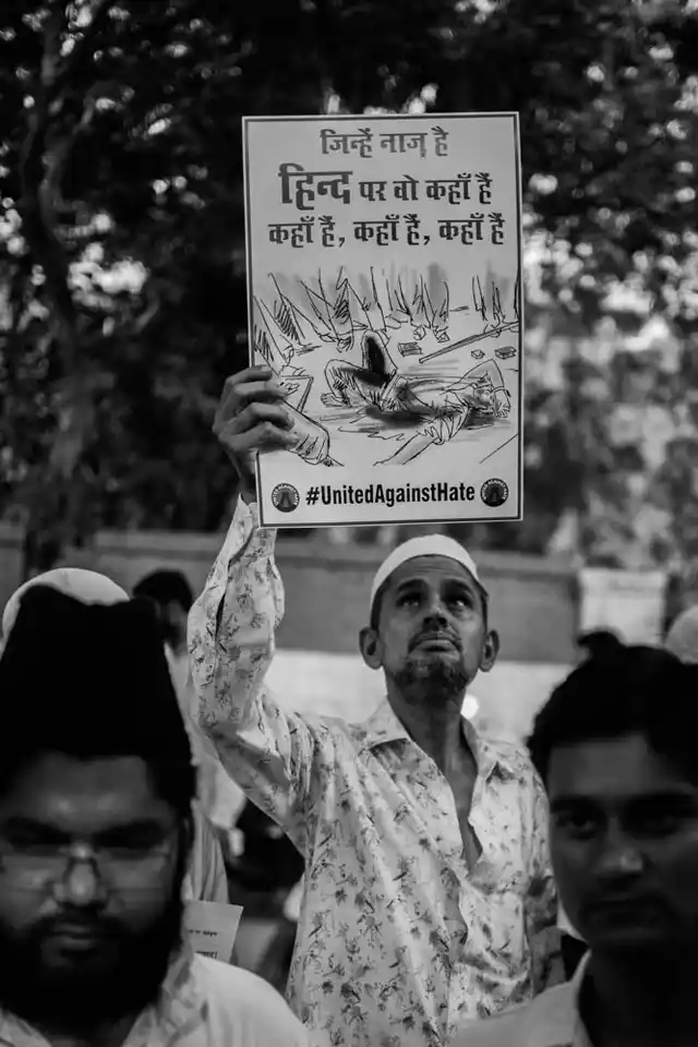 A man holds up a placard at the protest against lynching in Jantar Mantar. 