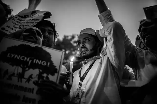 A man holds a candle to protest against the recent lynching of a 24-year-old in Jharkhand. 