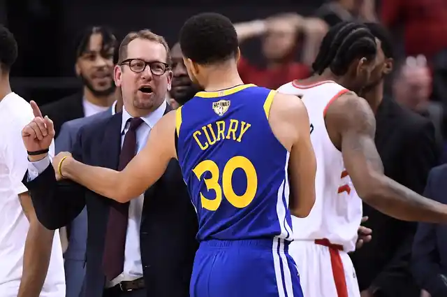 Toronto Raptors head coach Nick Nurse and Golden State Warriors guard Stephen Curry (30) exchange words.