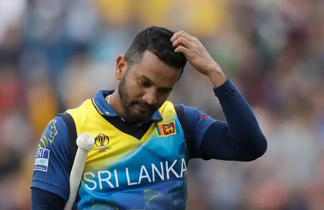 Sri Lanka’s captain Dimuth Karunaratne leaves the pitch after he is caught by Australia’s Glenn Maxwell for 97 during the World Cup cricket match between Sri Lanka and Australia at The Oval in London, Saturday, June 15, 2019.
