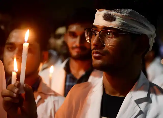 A doctor wears a bandage on his head as he participates in a rally to show solidarity with protests against an attack on a junior doctor in West Bengal, at Bikaner, Sunday, 16 June 2019.