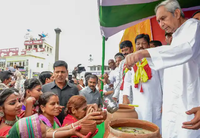 Odisha Chief Minister Naveen Patnaik distributes Abhada Torani to devotees during the annual Rath Yatra in Puri.
