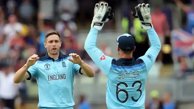 England’s bowler Chris Woakes, left, celebrates with teammate England’s Jos Buttler after dismissing Australia’s batsman Mitchell Starc for 29 runs during the Cricket World Cup semi-final match between Australia and England at Edgbaston in Birmingham.