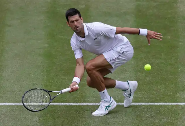 Serbia’s Novak Djokovic returns the ball to Belgium’s David Goffin during a men’s quarterfinal match on day nine of the Wimbledon Tennis Championships in London.