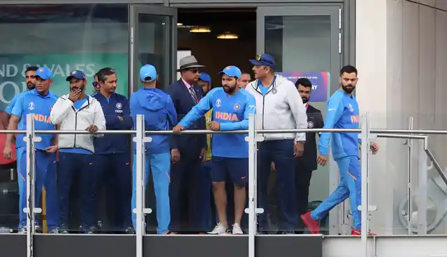 India’s captain Virat Kohli, right, stands in the pavilion with teammates after their team lost the Cricket World Cup semifinal match between India and New Zealand at Old Trafford in Manchester, Wednesday, July 10, 2019.