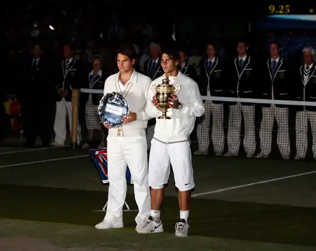 In this Sunday, July 6, 2008 file photo Spain’s Rafael Nadal right, stands with the winners trophy next to Switzerland’s Roger Federer after the men’s singles final on the Centre Court at Wimbledon.