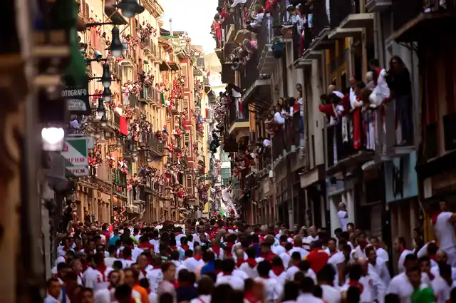 Revellers in the street ahead of the running of the bulls during the San Fermin Festival, in Pamplona, northern Spain.