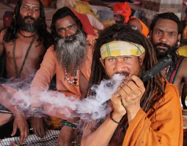 A sadhu smokes marijuana after the Amarnath Yatra was suspended due to the third death anniversary of former Hizbul Mujahideen commander Burhan Wani, at Bhagwati Nagar base camp in Jammu.