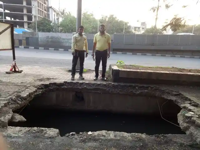 A sunken manhole at Bandra East WeH, opposite Gandhi Nagar building. 