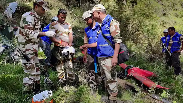 ITBP personnel conduct search operation at the site of wreckage of the private helicopter.