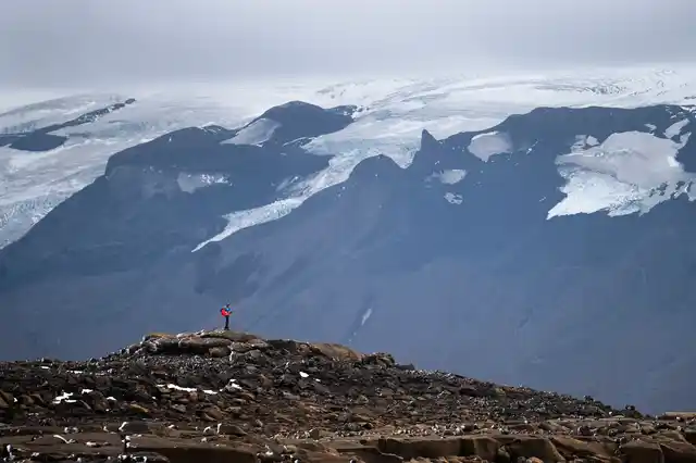 A man stops on his way to the top of what once was the Okjokull glacier, in Iceland, Sunday,18 August 2019.