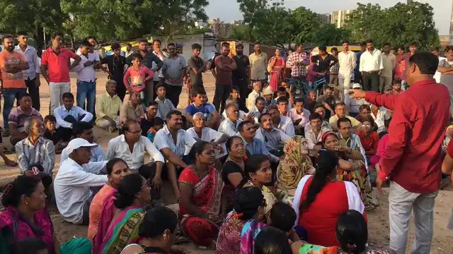 Members of RDAM speak with the now homeless residents of the low income housing scheme in Odhav, Ahmedabad.